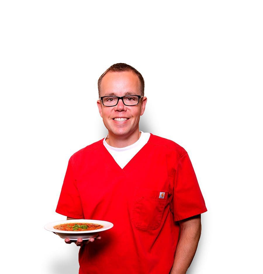 Peter Weiss holding a bowl of Butternut Squash soup.