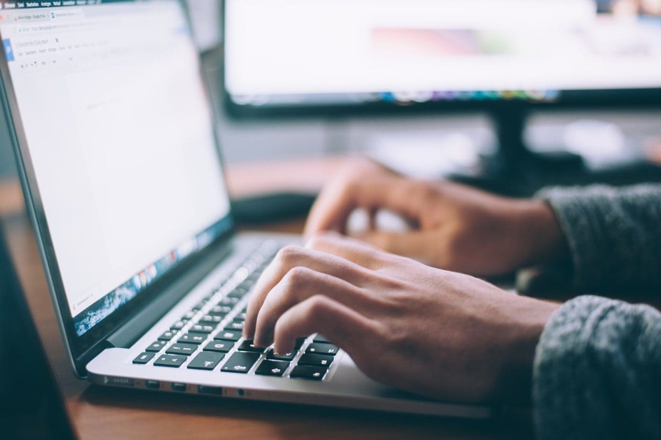 hands-typing-laptop-computer