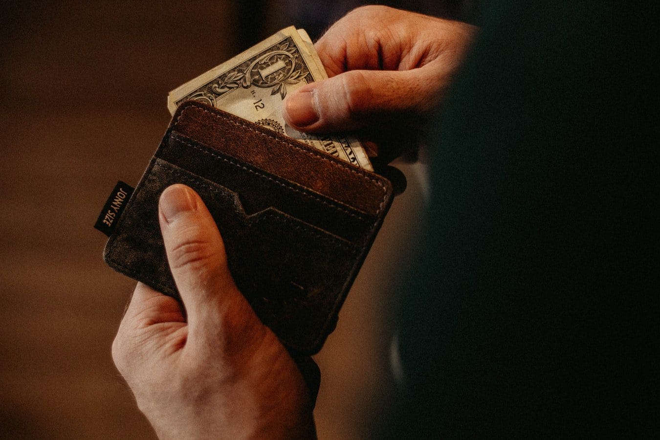 hands-holding-wallet-with-money