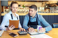 two-people-at-desk-in-market