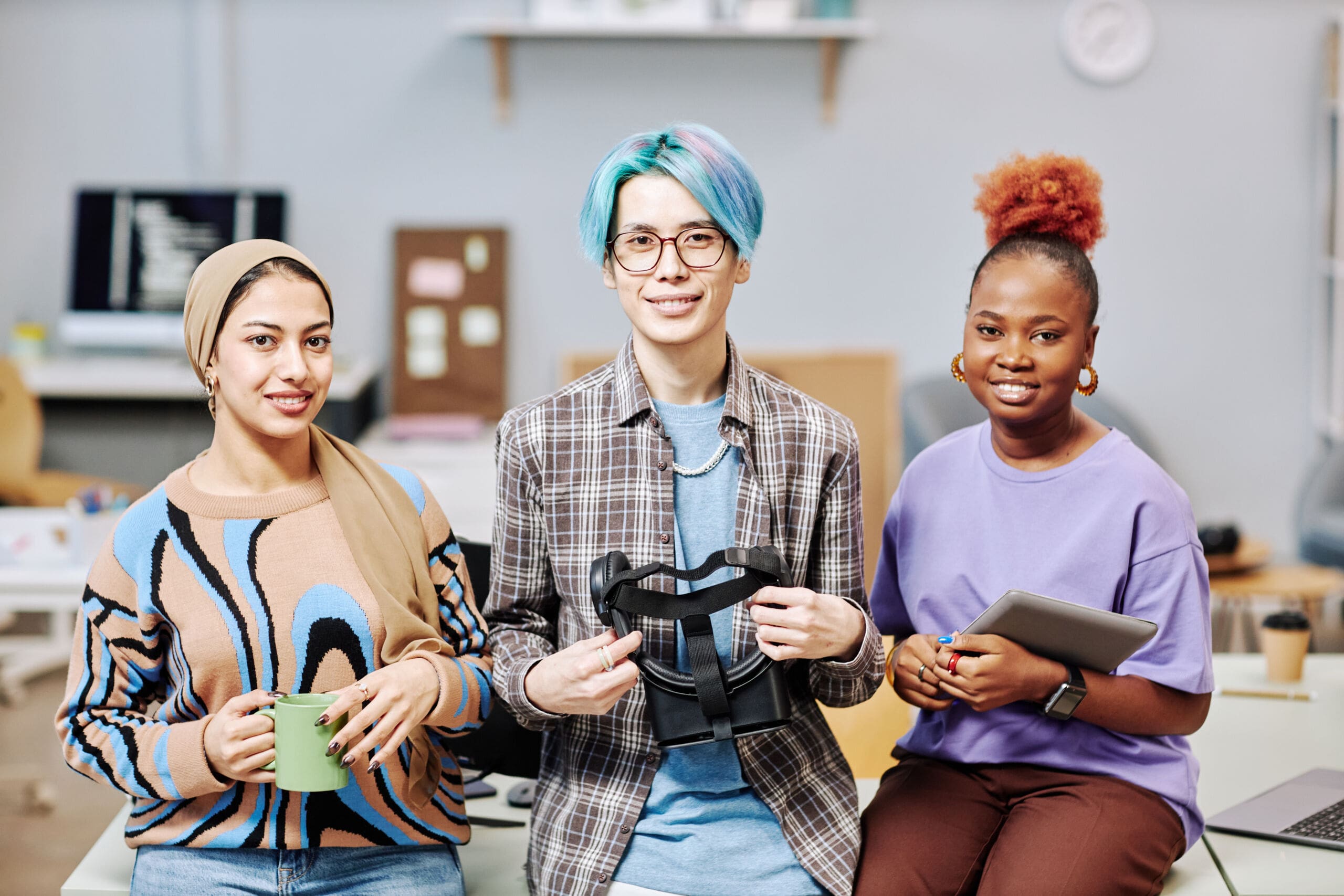 Team of creative young professionals looking at camera in office