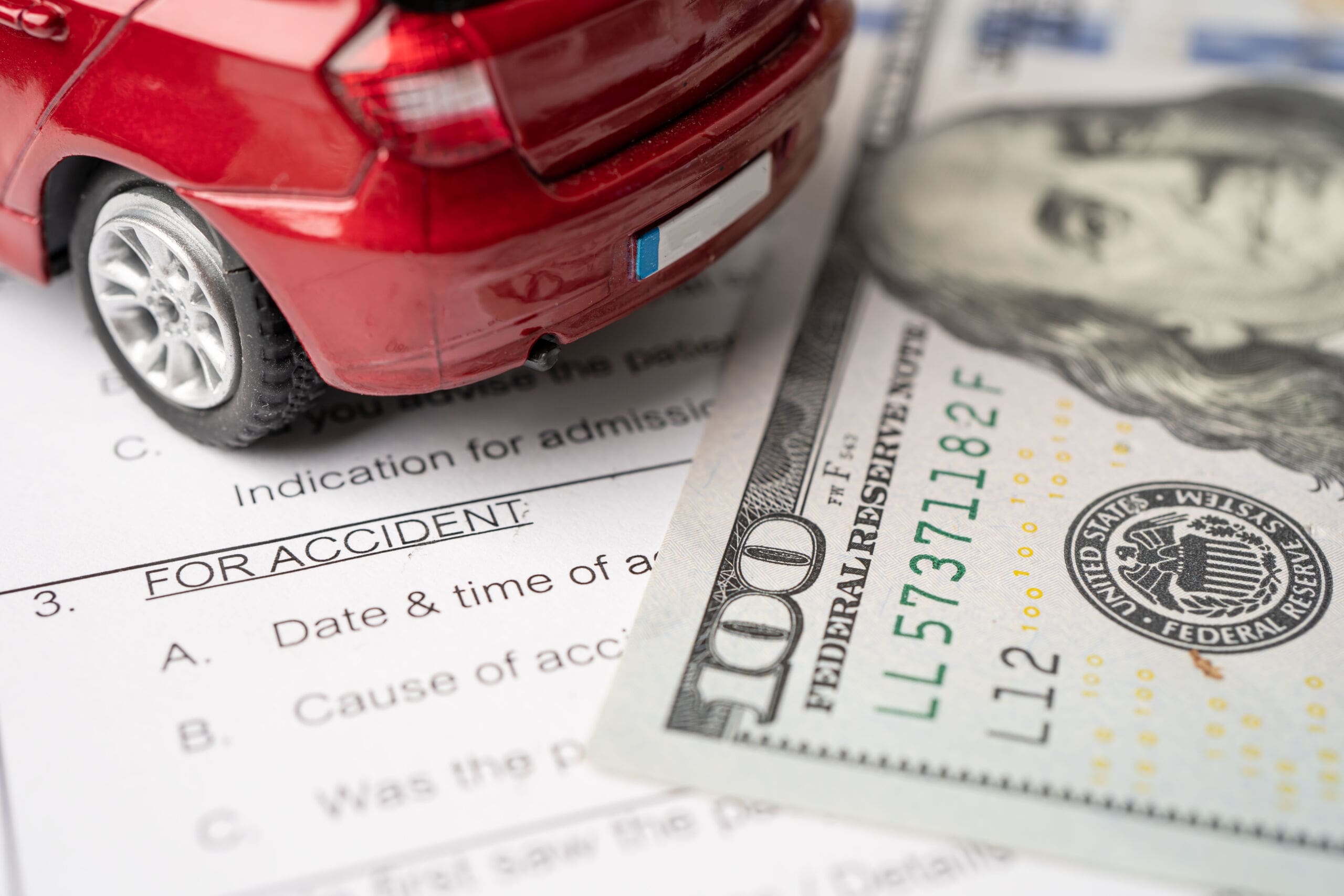 Health insurance accident claim form with US dollar banknotes mo